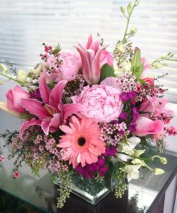 pink peonies daisies lilies and green accents in vase