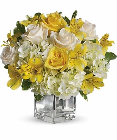 A warm and sunny bouquet with yellow and ivory roses, white hydrangea, and yellow alstroemeria are sure to brighten anyone's day.
