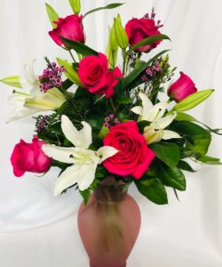 This delightfully fragrant bouquet of hot pink roses and white lilies will make a lasting impression for any occasion.